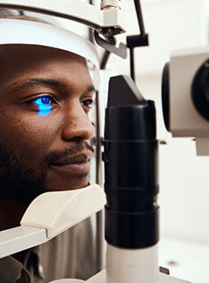 Man getting an eye health exam in Bard Optical Peoria Shoppes at Grand Prairie