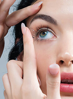 Women putting contact lenses on their eye